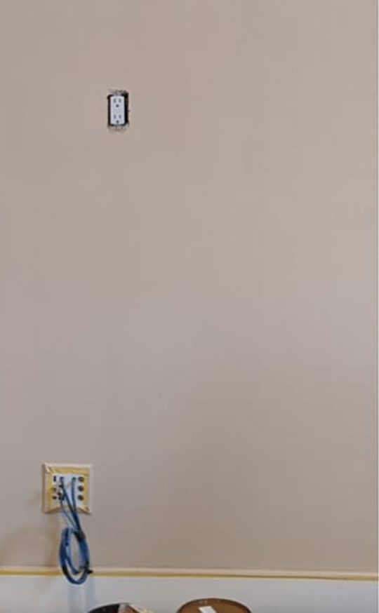 After: the same wall finished in a smooth, even light beige